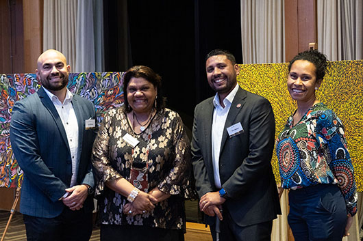 WTA 1 Group of people in from of Aboriginal artwork at WTA2019